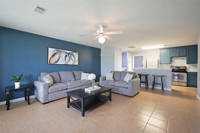 Living area featuring baseboards, visible vents, c