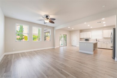 Unfurnished living room with a sink, ceiling fan,