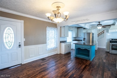 Kitchen featuring ornamental molding, backsplash, ceiling fan, decorative light fixtures, and open shelves
