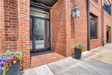 Property entrance featuring 4 sided brick siding, private parking garage and secure entrances for the Residents