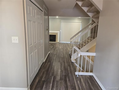 Hallway with stairway and dark wood-type flooring