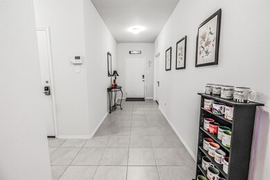 Hall featuring light tile floors