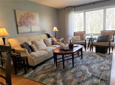 Large living room features seating area with TV, fireplace, and office space.