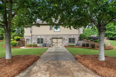 View of front of property with stone siding, a gar