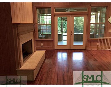 Living Room. Cypress walls and pine flooring; rais
