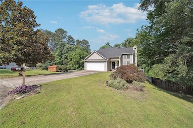 View of front of property featuring concrete driveway and a garage