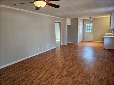 Unfurnished living room with dark wood-style floor