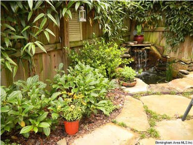 Year Around Green Shrubs, flagstone patio & Koi Po