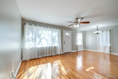 Entrance foyer with ceiling fan, light wood-type flooring