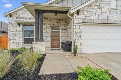 View of exterior entry with stone siding, board a