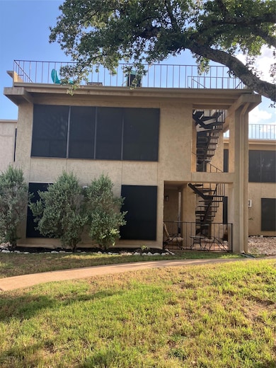 View of front facade with stairs, stucco siding, 