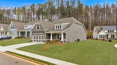 Craftsman house with a shingled roof, concrete driveway, central AC unit, and a front lawn