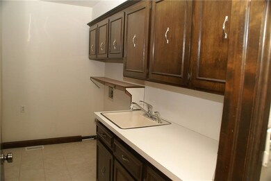 Laundry room with only half of the cabinetry shown