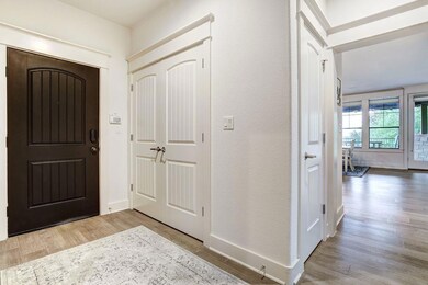 Foyer with wood finished floors and baseboards