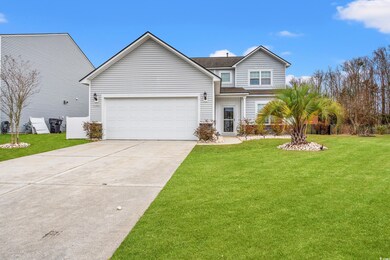 View of front of home featuring a garage, concrete