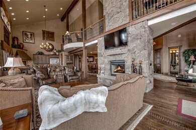Living area with a stone fireplace, wood finished