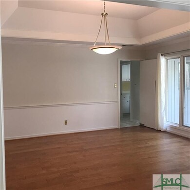 Dining room with tray ceiling and a wall of window