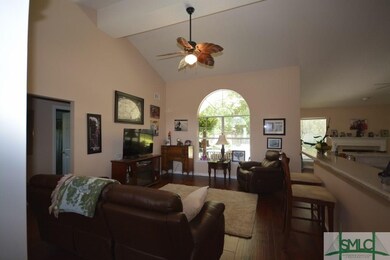 Large open living room with soaring ceilings, arch