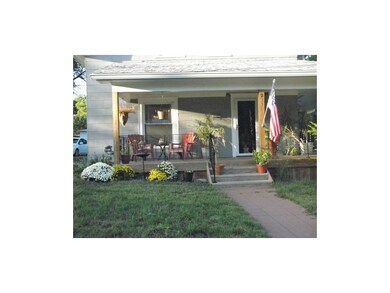 beautiful fall mums, porch that wraps all the way 