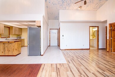 Living/dining area facing front door and bathroom