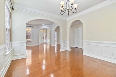 Unfurnished dining area with a chandelier, crown m