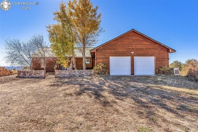 View of front of house featuring an attached garage and a metal roof