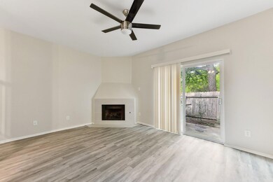 Unfurnished living room with a ceiling fan, a til