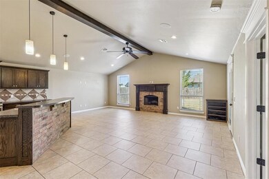 Kitchen with pendant lighting, dark brown cabinetry, tasteful backsplash, light tile patterned floors, and a kitchen breakfast bar