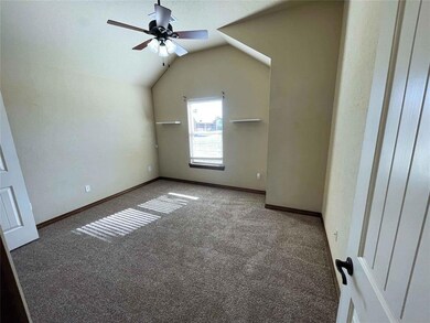 Additional living space with ceiling fan, dark car