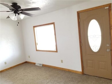 Bright sunlit living room with new ceiling fan/lig