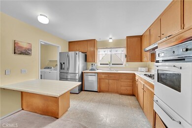 Kitchen With Gas Cooktop And Separate Oven, Stainless Steel Dishwasher, Center Peninsula With Seating And Storage