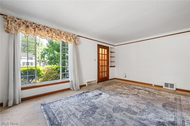 Carpeted living room with a healthy amount of sunlight