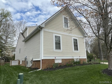 View of side of home featuring a yard