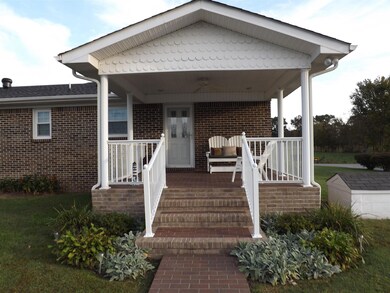 Relax with morning coffee on this peaceful back porch that opens to the kitchen.  Amenities include a ceiling fan and recessed lighting.