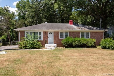 Ranch-style home featuring a front lawn