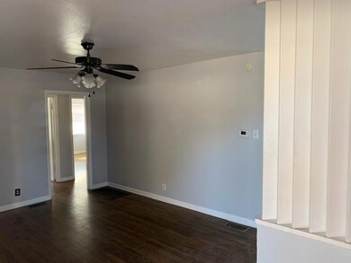 Unfurnished room with dark wood-style floors, visi