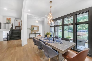 Dining room featuring stairway, light wood-style flooring, recessed lighting, and baseboards
