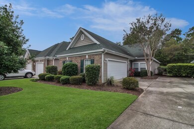 Ranch-style house featuring brick siding, roof with shingles, a front lawn, and driveway