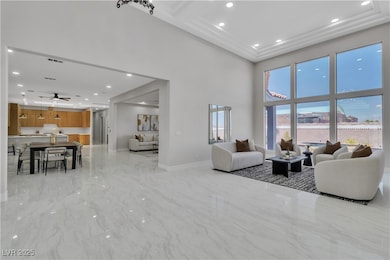 Living room with a towering ceiling, light marble