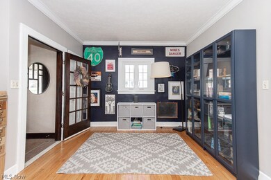 Office space featuring light hardwood / wood-style flooring and crown molding