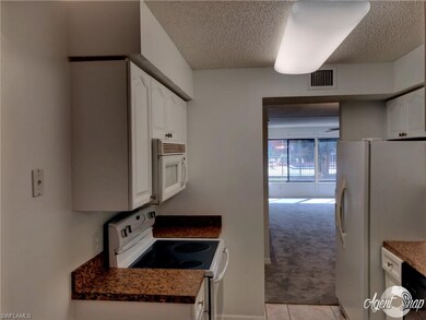 Bright kitchen with new microwave, tiled floors th
