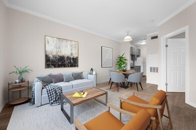 Living area with crown molding, wood finished flo