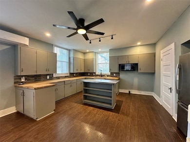 Kitchen featuring butcher block countertops, stain