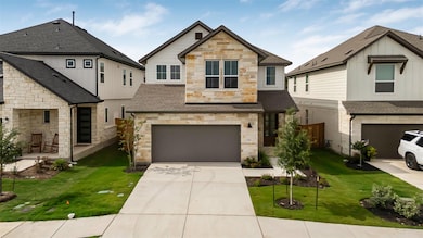 View of front of home featuring stone siding, an 