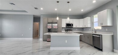 Kitchen with light marble finish floors, a kitchen