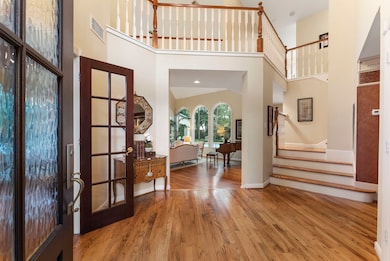 This welcoming foyer features elegant hardwood flo