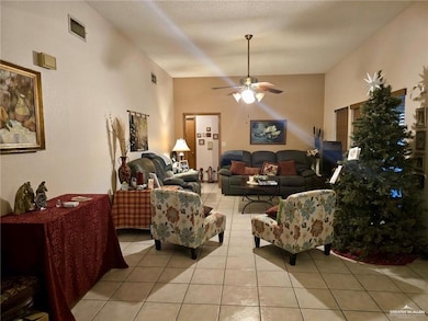 Living room with light tile patterned floors and ceiling fan