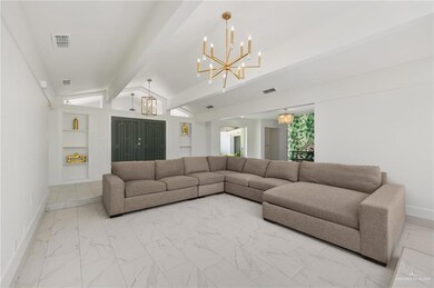 Living room featuring a chandelier, vaulted ceiling with beams, built in features, and light tile patterned floors
