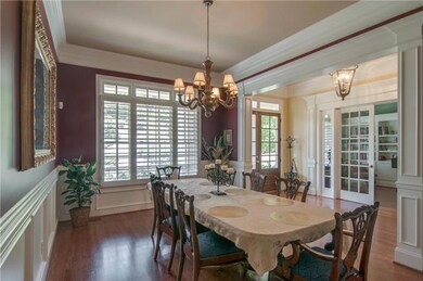 The dining room is loaded with details...heavy crown molding, chair rail, wainscoting and detailed columns to welcome you into the room.  Of course, you can se the plantation shutter and transom windows.  These will be in other rooms as wel