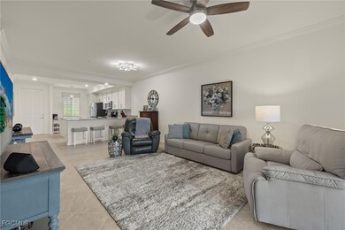 Living room featuring ornamental molding, light tile patterned flooring, ceiling fan, and recessed lighting